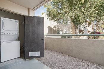 A washing machine is sitting in a small outdoor space. at The Viridian Apartments, Scottsdale